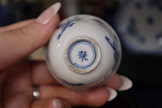 An 18th century Chinese blue and white tea bowl and saucer, and a similar bowl and two hardwood stands